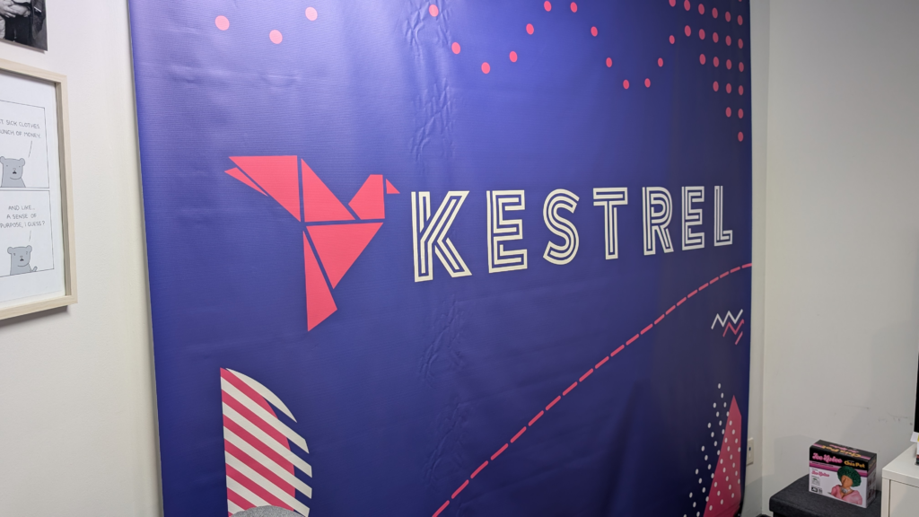 The Kestrel banner from WordCamp Canada as a backdrop in my office